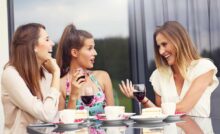 Tre ragazze avvenenti conversano e sorridono