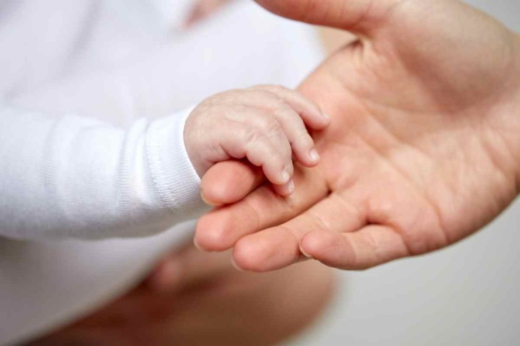 mani neonato e mano mamma