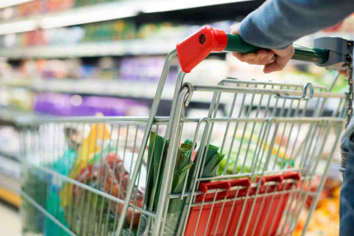 Uomo che spinge carrello in un supermercato