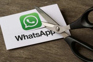Illustrazione logo WhatsApp che viene tagliato con le forbici